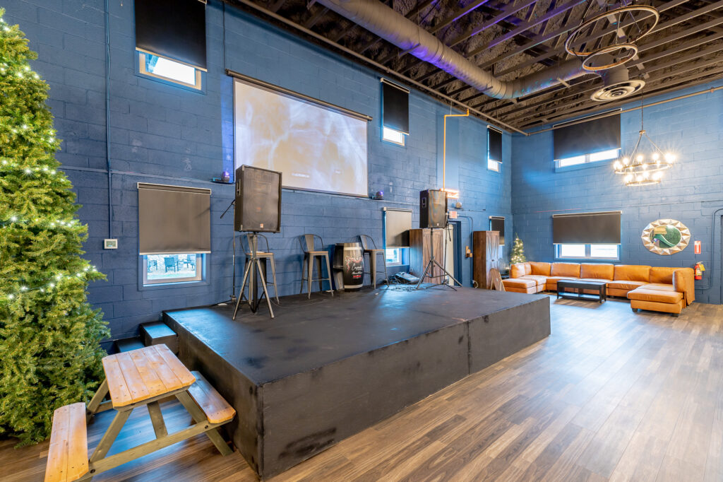 Stage area at Rock Spring Resort with projector, sound equipment, and seating - ideal for parties, presentations, or live music.