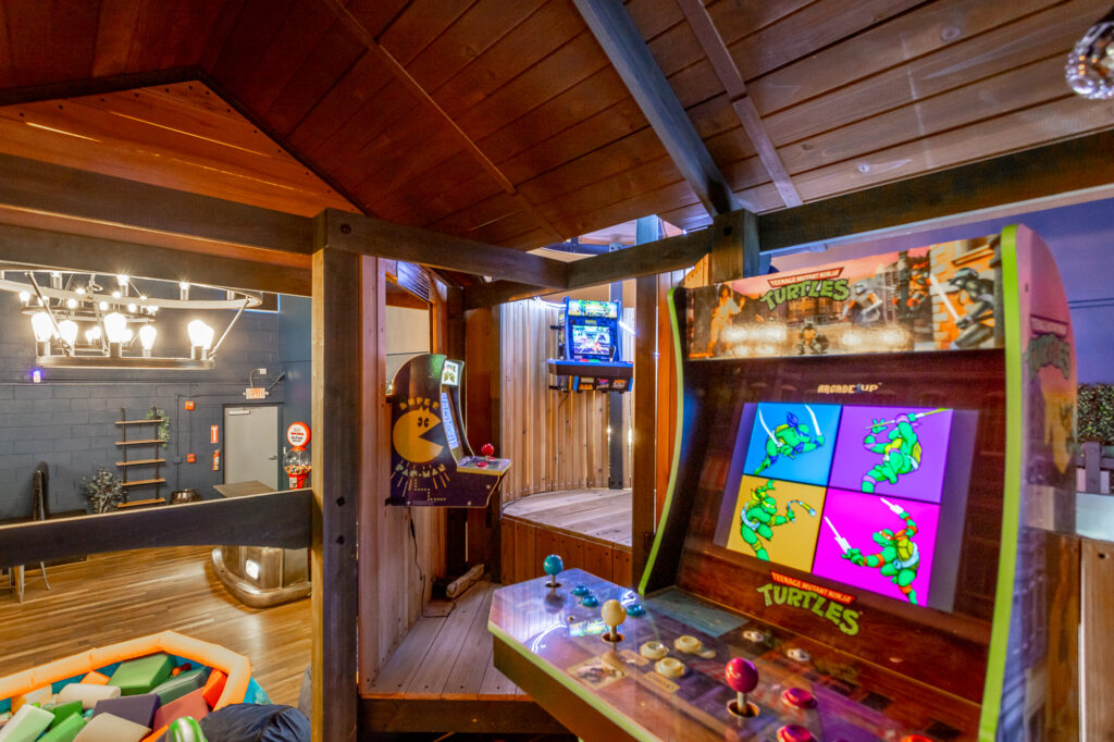 View from inside the Arcade Treehouse at Rock Spring Resort, showing ball pit, arcade games, and event space.